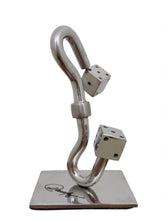 Load image into Gallery viewer, Fresh from the exhibition at the Carousel du Louvre, this sculpture is vaguely suggestive of games of chance, LOUVRE/PRAISE, by sculptor Luiz Campoy. The sculpture has a gleaming stainless steel body punctuated with a pair of dice, raised on a solid stain