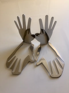 An abstract expression, this modern set of stainless steel hands are upright yet, also mirrored in their base. Signed by the artist, this piece is laser cut, with a thickness of 5mm solid, and the contour of the piece provides the solid base of the sculp