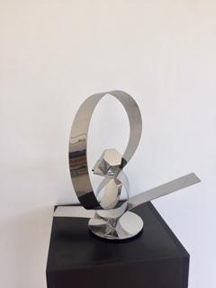 His ingenious conceptual art creations are contemporary forms that are aesthetically pleasing to the viewer, left for interpretation. These stainless steel plate tapes are guillotine cut, twisted and welded to create movement, an action and reaction. Ar